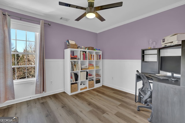 office space featuring a wainscoted wall, plenty of natural light, visible vents, and wood finished floors