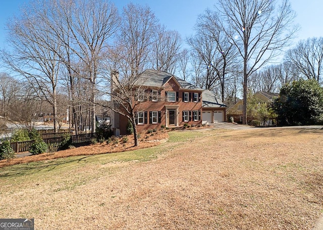 view of front of property with a garage, driveway, a front yard, and fence