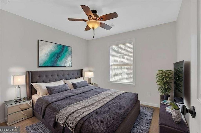 bedroom featuring carpet, ceiling fan, visible vents, and baseboards