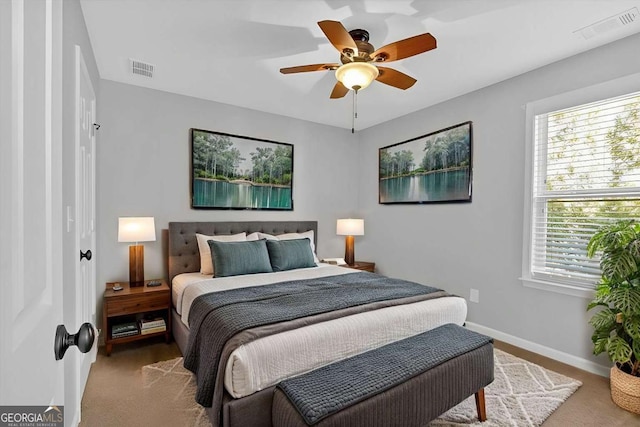 bedroom featuring baseboards, multiple windows, and visible vents