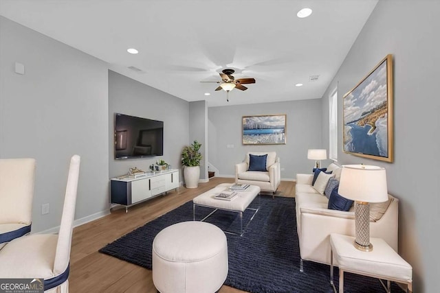 living area with ceiling fan, baseboards, wood finished floors, and recessed lighting