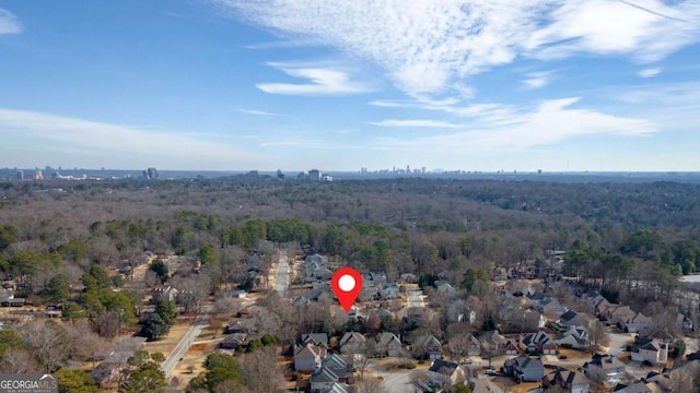 drone / aerial view featuring a residential view and a view of trees