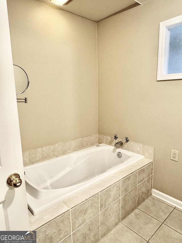 bathroom featuring tile patterned flooring and a bath