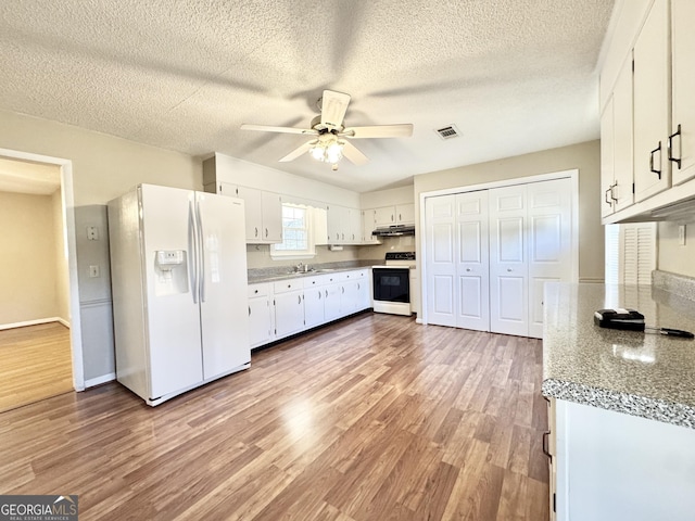 kitchen featuring visible vents, light wood-style flooring, white cabinets, white appliances, and under cabinet range hood