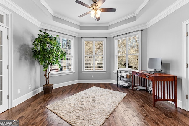 office with crown molding, a tray ceiling, wood-type flooring, and baseboards