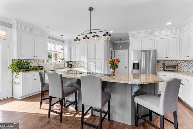 kitchen featuring hardwood / wood-style floors, a center island, white cabinetry, and stainless steel fridge with ice dispenser