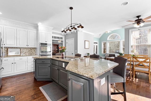 kitchen with white cabinetry, black electric stovetop, gray cabinets, and a ceiling fan