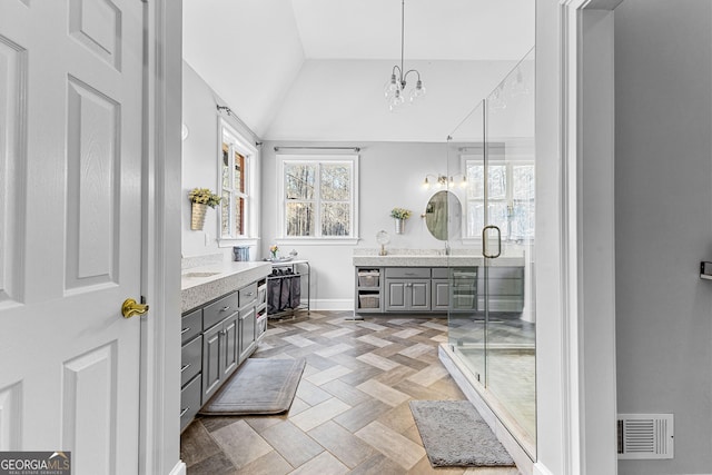 full bath featuring lofted ceiling, a shower stall, visible vents, and vanity