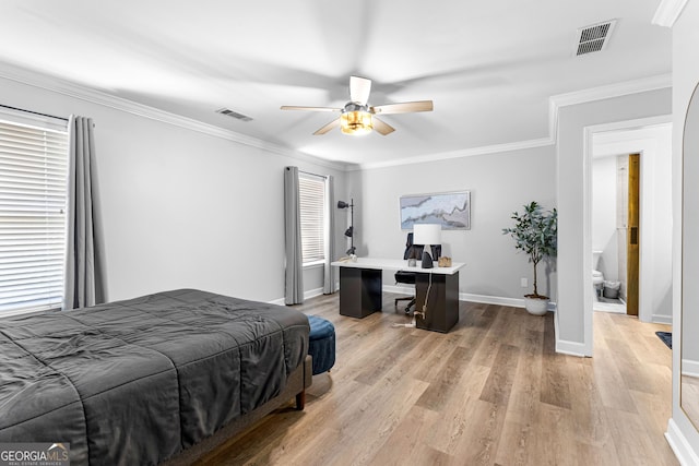 bedroom with light wood finished floors, baseboards, visible vents, and ornamental molding