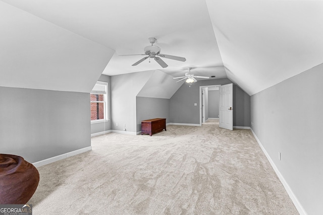 bonus room with lofted ceiling, a ceiling fan, baseboards, and carpet flooring