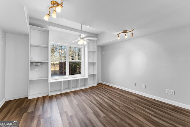 unfurnished living room featuring a ceiling fan, built in shelves, baseboards, and wood finished floors