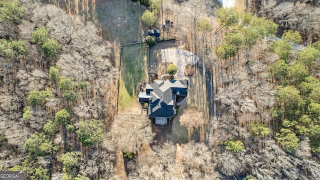 drone / aerial view featuring a forest view