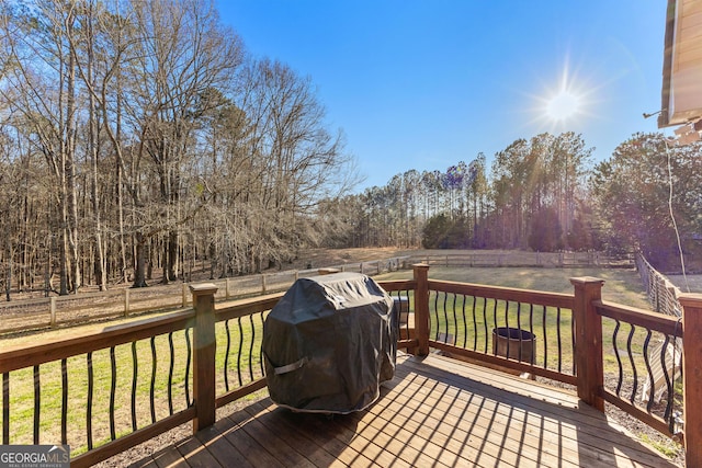 wooden deck with a yard, area for grilling, and a fenced backyard