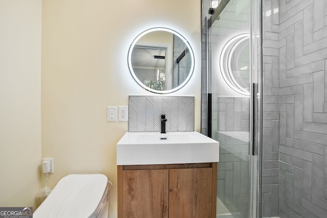 full bath featuring toilet, vanity, and a shower stall