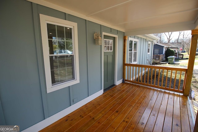 wooden terrace featuring covered porch