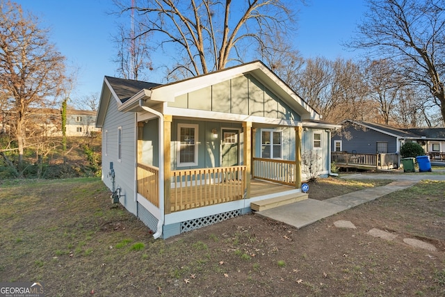 bungalow-style home featuring covered porch and board and batten siding