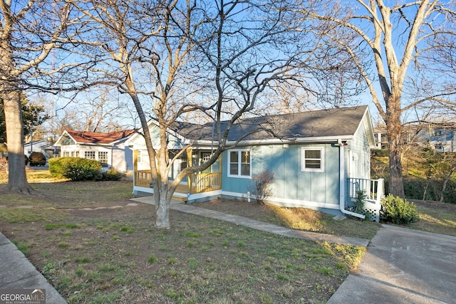 view of front facade featuring board and batten siding and a front lawn