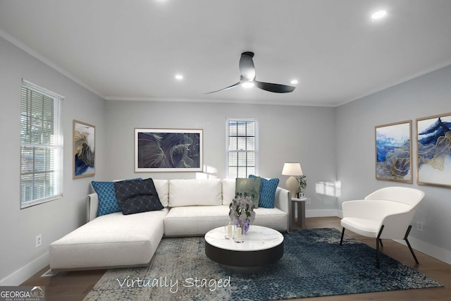 living area featuring baseboards, ceiling fan, wood finished floors, and crown molding