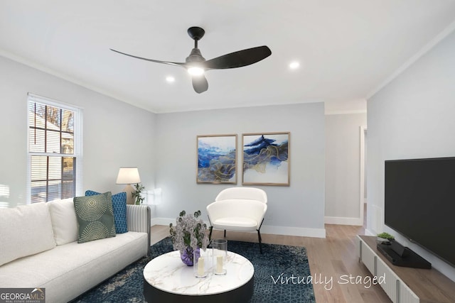 living area featuring recessed lighting, ornamental molding, baseboards, light wood-style floors, and ceiling fan