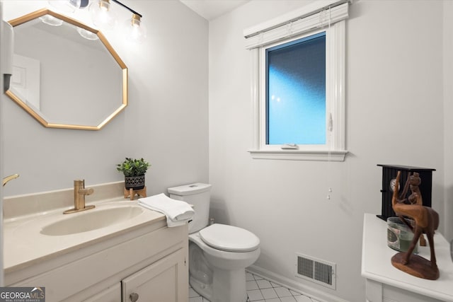 bathroom featuring visible vents, vanity, and toilet