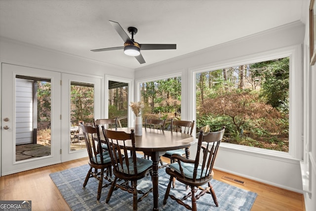 sunroom with ceiling fan and visible vents