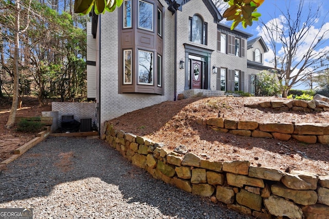 view of side of property with brick siding