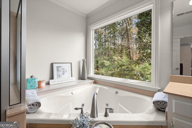 full bath with visible vents, ornamental molding, a jetted tub, and vanity