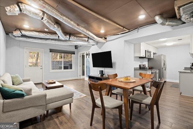 interior space featuring baseboards and dark wood finished floors