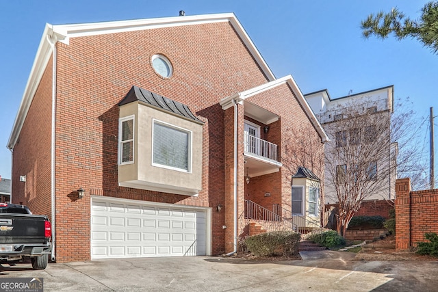 view of front of property featuring concrete driveway, brick siding, and an attached garage