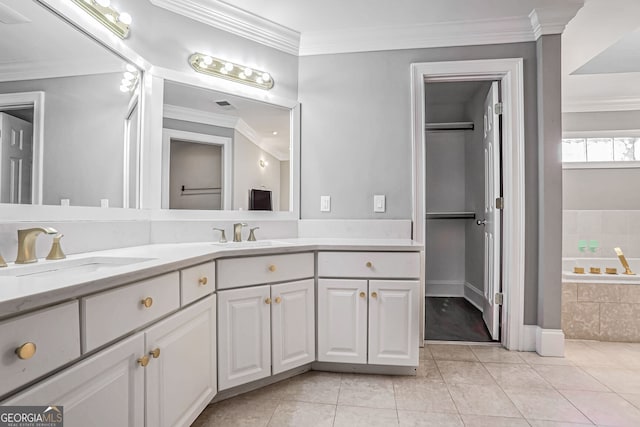 bathroom featuring ornamental molding, tile patterned floors, a sink, and a bath