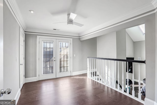 empty room with ornamental molding, french doors, visible vents, and dark wood-style flooring