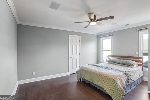 bedroom featuring ornamental molding, multiple windows, dark wood finished floors, and baseboards