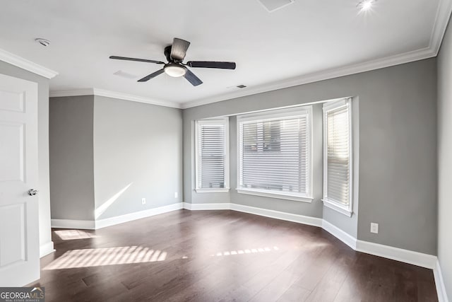 spare room featuring ornamental molding, dark wood-style flooring, baseboards, and a ceiling fan