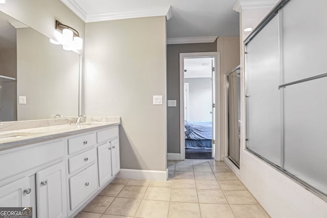 ensuite bathroom with crown molding, double vanity, a sink, ensuite bath, and tile patterned flooring