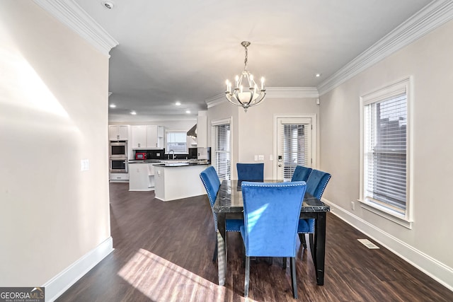 dining area featuring a chandelier, ornamental molding, visible vents, and a healthy amount of sunlight