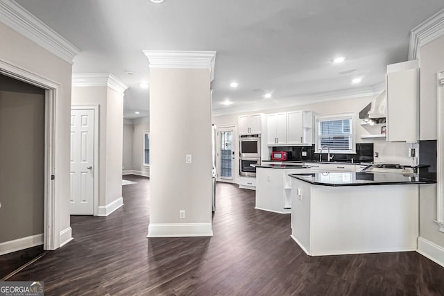 kitchen featuring dark countertops, appliances with stainless steel finishes, dark wood-style flooring, white cabinetry, and open shelves