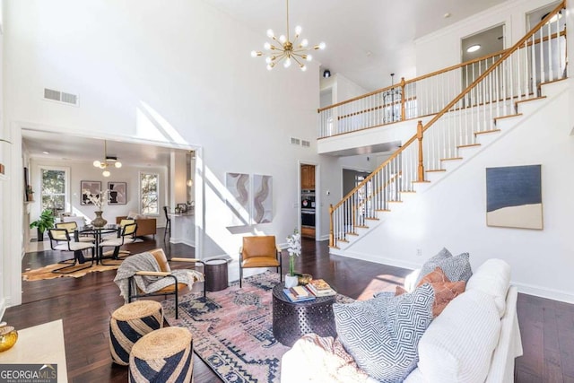 living room featuring baseboards, visible vents, dark wood finished floors, stairway, and a notable chandelier