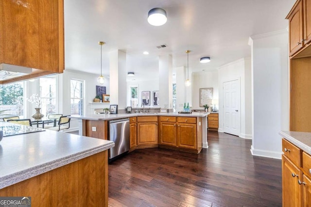 kitchen with a peninsula, light countertops, stainless steel dishwasher, and hanging light fixtures