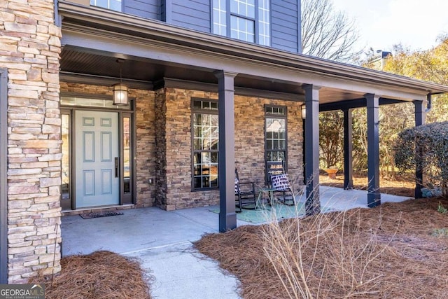 entrance to property featuring stone siding and a porch