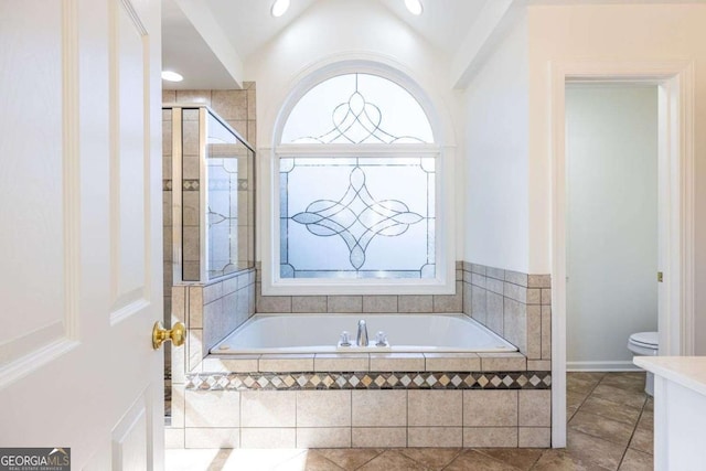 full bathroom featuring toilet, plenty of natural light, vaulted ceiling, and a bath