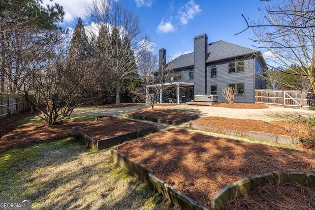 view of yard featuring a vegetable garden and fence