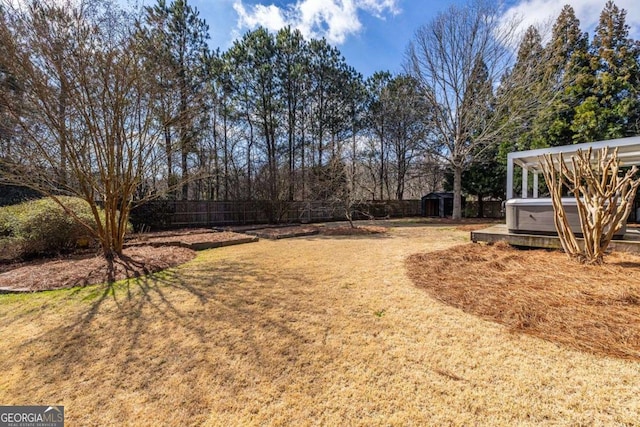 view of yard featuring a fenced backyard and a hot tub