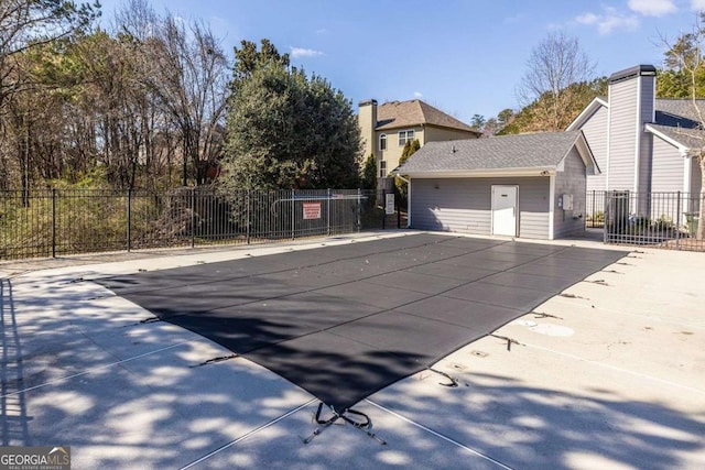 view of pool with a patio area and fence