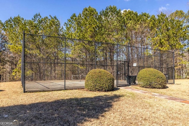 view of property's community featuring a gate, fence, and a lawn