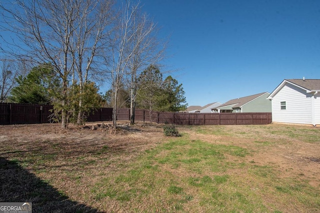 view of yard with a fenced backyard