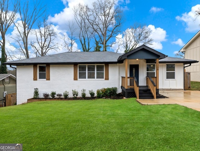 ranch-style house featuring driveway, board and batten siding, and a front yard