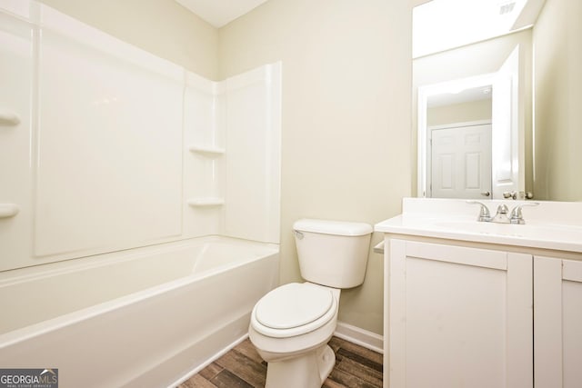 full bath featuring shower / bathing tub combination, toilet, vanity, wood finished floors, and baseboards