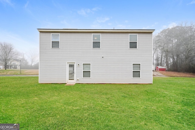 rear view of house with a yard