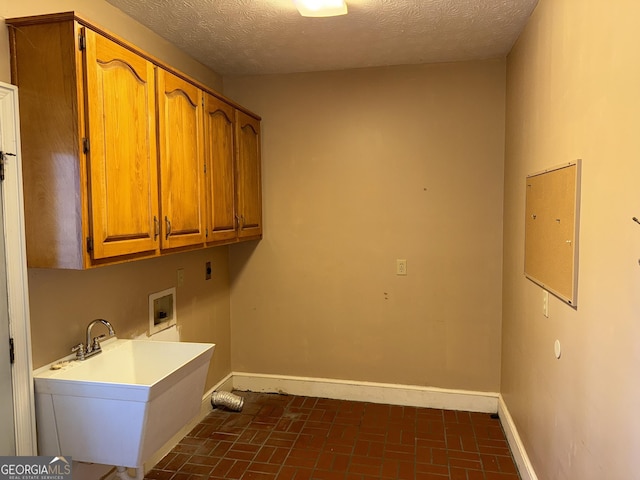 laundry area featuring washer hookup, a sink, baseboards, cabinet space, and electric dryer hookup