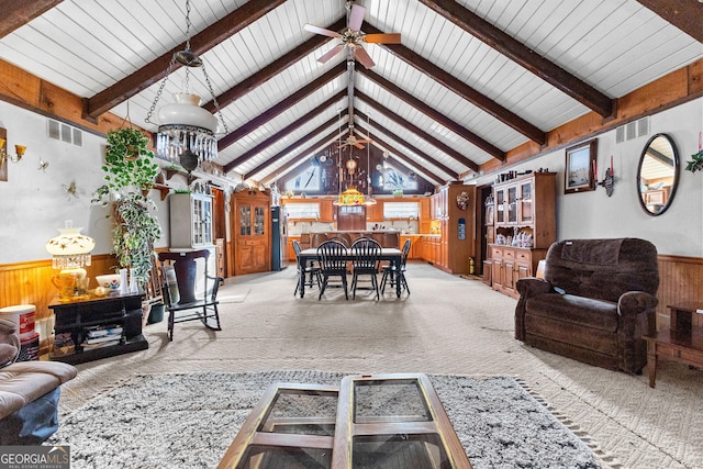 82 Swan Ave, Newnan, GA 30263 - living room featuring wooden walls, a wainscoted wall, beam ceiling, light colored carpet, and ceiling fan